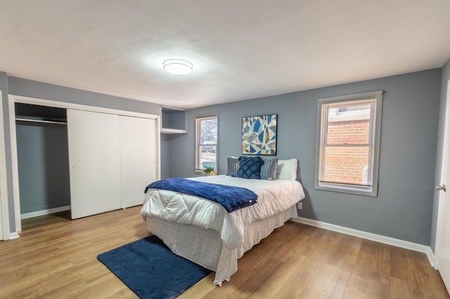 bedroom featuring light wood-type flooring and a closet