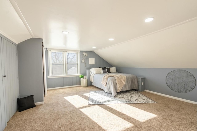 bedroom featuring light colored carpet and lofted ceiling