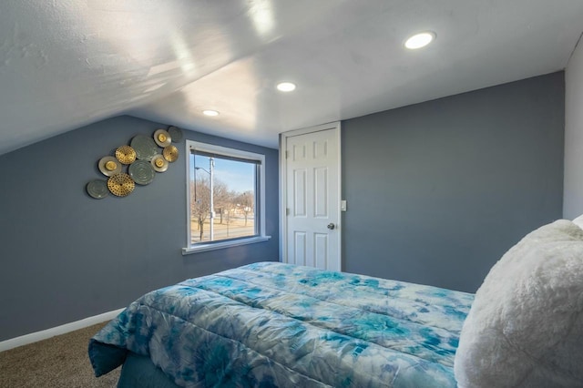 bedroom with carpet floors and lofted ceiling