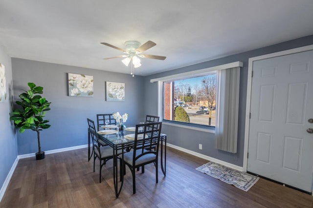 dining space with ceiling fan and dark hardwood / wood-style floors