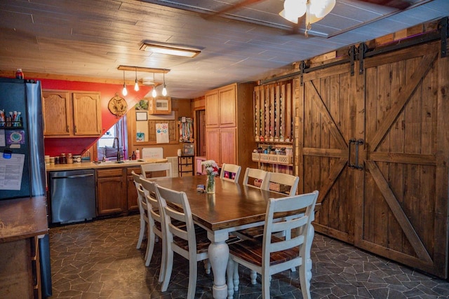 dining room with wood ceiling, a barn door, and sink