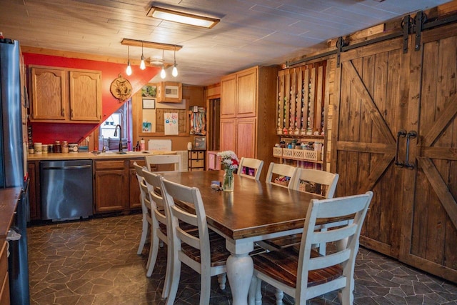 dining space with sink and a barn door