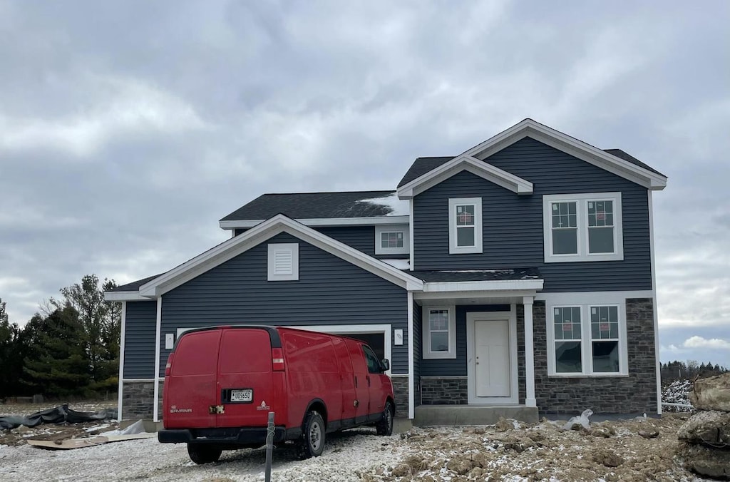 N161W21815 Daisy Dr, Jackson, WI 53037 - view of front facade with an attached garage and stone siding