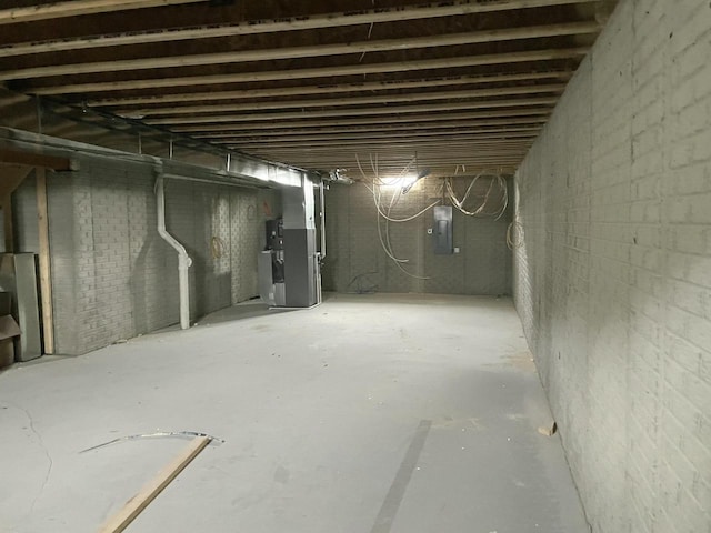 basement featuring heating unit and electric panel