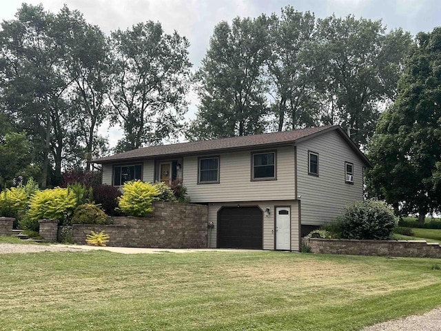 view of front of property featuring a garage and a front lawn