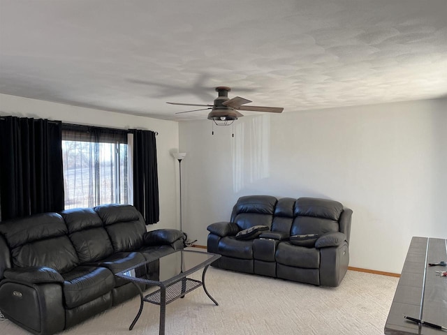 carpeted living room featuring ceiling fan