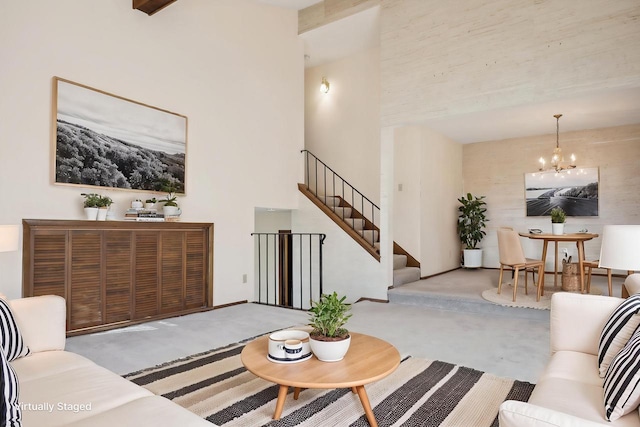 living room featuring a high ceiling, beam ceiling, and a chandelier