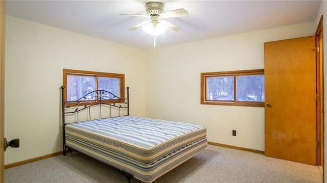 bedroom with ceiling fan and light carpet