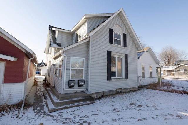 view of snow covered rear of property