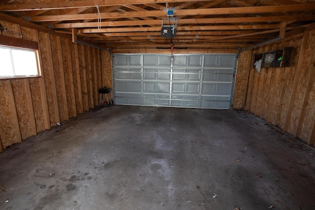 garage featuring wooden walls and a garage door opener