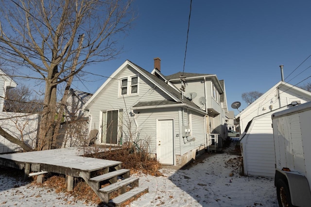 view of snow covered back of property