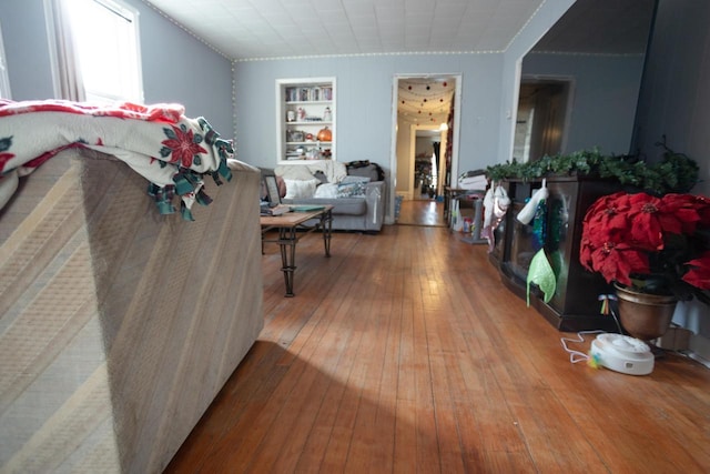 living room with hardwood / wood-style flooring and built in features