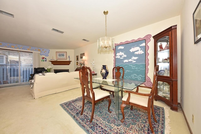 dining room with light carpet and an inviting chandelier