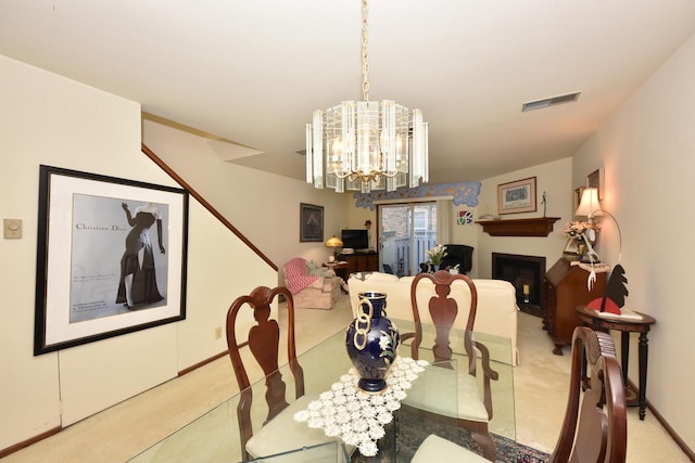 dining space featuring light carpet and an inviting chandelier