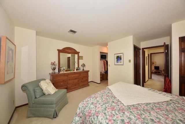 bedroom featuring a closet and light colored carpet