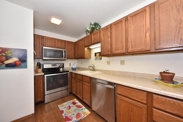 kitchen with dark hardwood / wood-style floors, sink, and stainless steel appliances