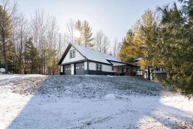 view of snow covered exterior featuring a garage