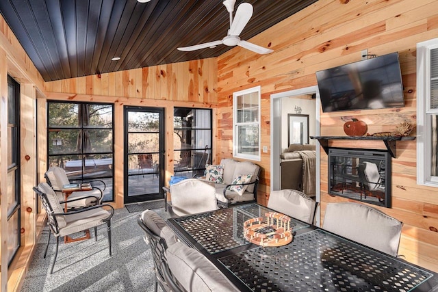 sunroom with ceiling fan, vaulted ceiling, and wood ceiling