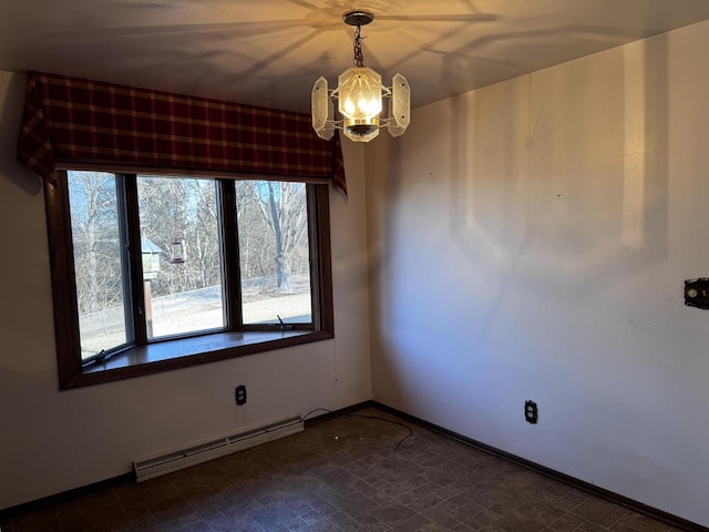 empty room featuring baseboard heating and a chandelier