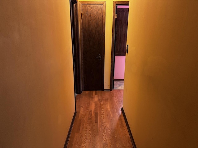 corridor with light hardwood / wood-style flooring