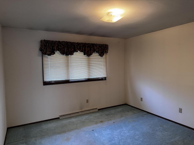 spare room with carpet floors and a baseboard radiator