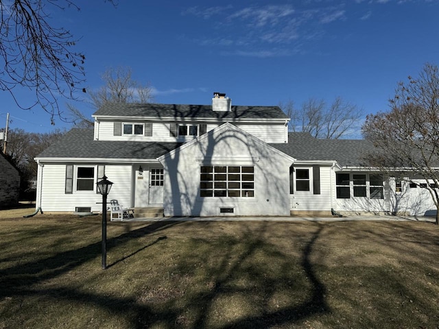 rear view of property with a yard