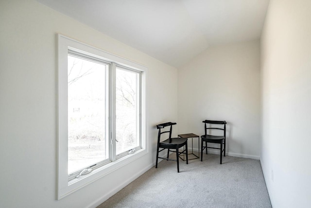 sitting room featuring vaulted ceiling and carpet flooring