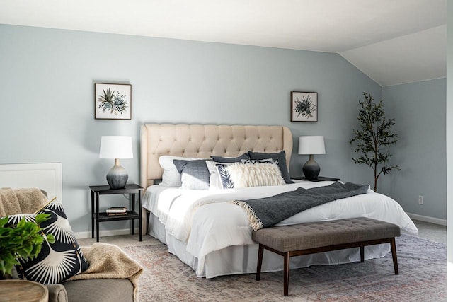 carpeted bedroom with vaulted ceiling