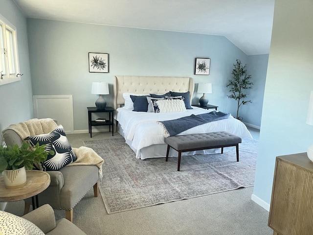 bedroom featuring vaulted ceiling and carpet