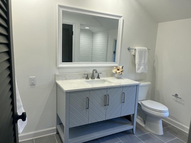 bathroom featuring vanity, toilet, and tile patterned flooring