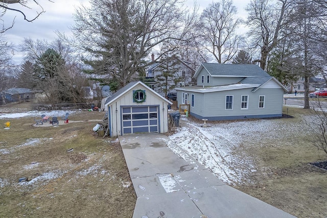 exterior space with a garage and an outbuilding