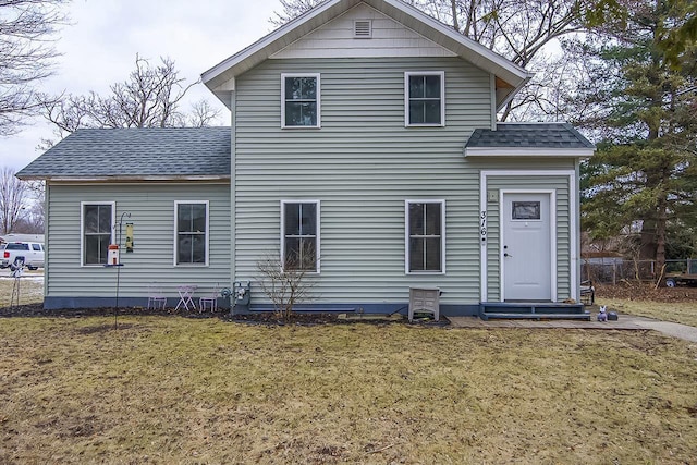 rear view of house with a lawn