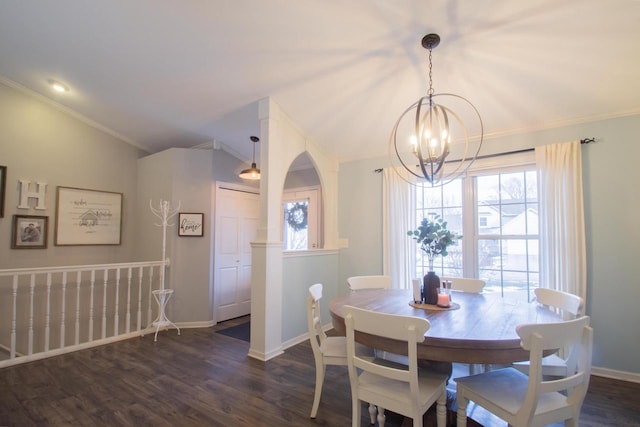 dining space featuring lofted ceiling, a notable chandelier, ornamental molding, and dark hardwood / wood-style floors