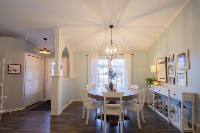 dining room featuring dark hardwood / wood-style flooring, crown molding, and an inviting chandelier