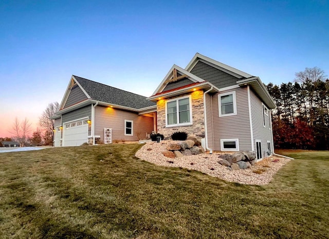 view of front facade with an attached garage, stone siding, and a yard