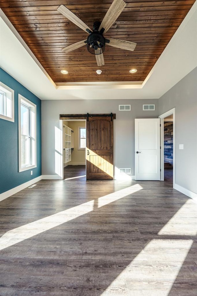 unfurnished living room featuring wooden ceiling, visible vents, and a tray ceiling