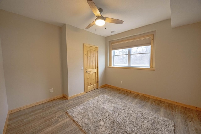 unfurnished bedroom featuring ceiling fan, wood finished floors, and baseboards