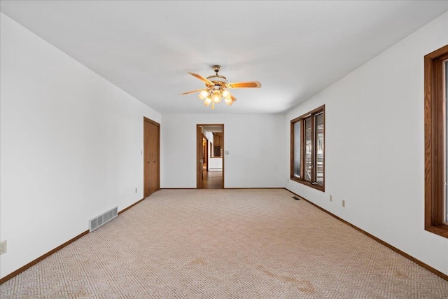 carpeted spare room with ceiling fan