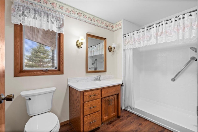 bathroom featuring wood-type flooring, toilet, vanity, and a shower with shower curtain