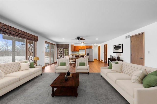 living room featuring ceiling fan and light hardwood / wood-style flooring