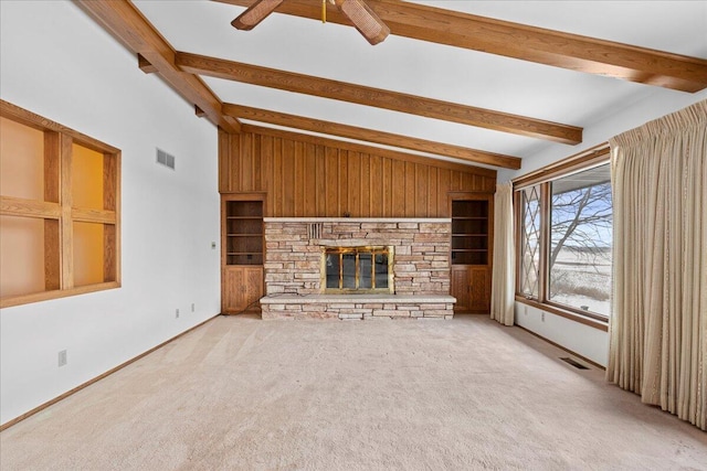 unfurnished living room featuring ceiling fan, light colored carpet, a stone fireplace, and lofted ceiling with beams