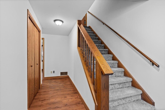 stairway with hardwood / wood-style flooring