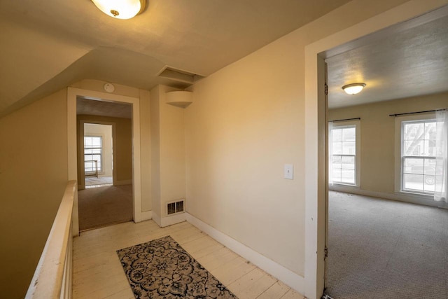 corridor featuring vaulted ceiling