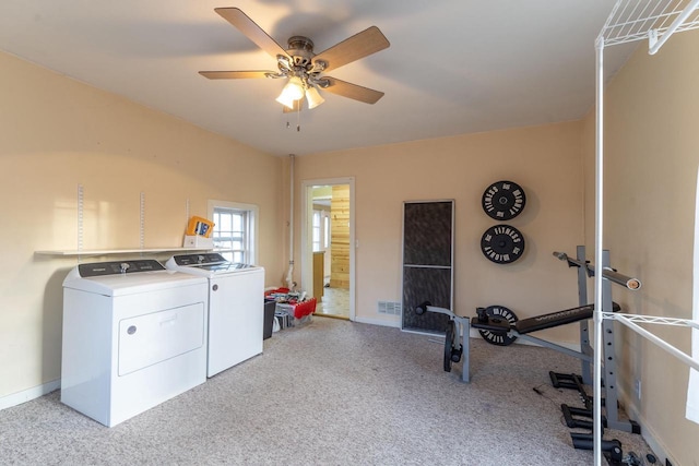 washroom with light colored carpet, washer and dryer, and ceiling fan