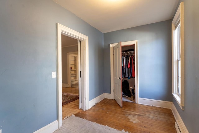 unfurnished bedroom with light hardwood / wood-style floors and a closet