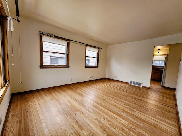 spare room featuring light hardwood / wood-style floors