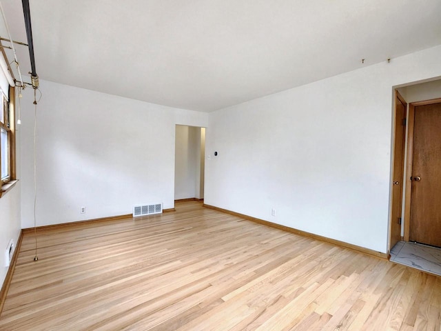 empty room with light hardwood / wood-style floors