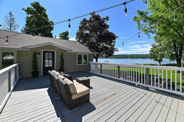 wooden terrace with an outdoor living space and a water view