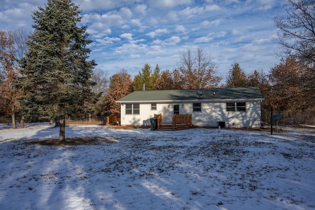 snow covered house featuring a deck