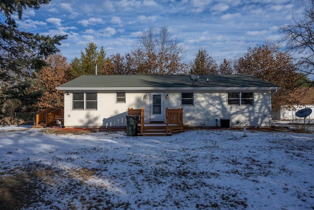 snow covered property with a wooden deck